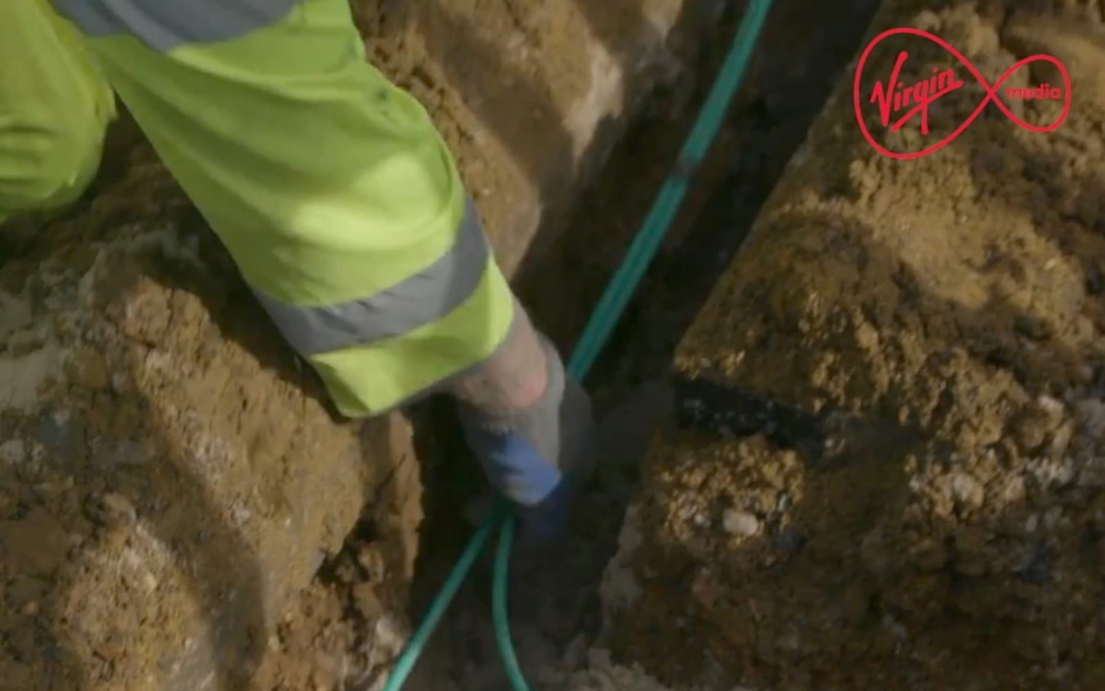 Picture of someone in high vis holding green cables and writing "we're boosting connectivity to the frontline"